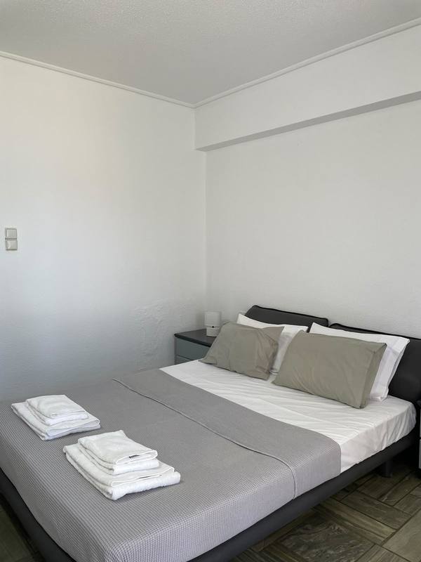 Bedroom with wooden bed frame and blue pillows