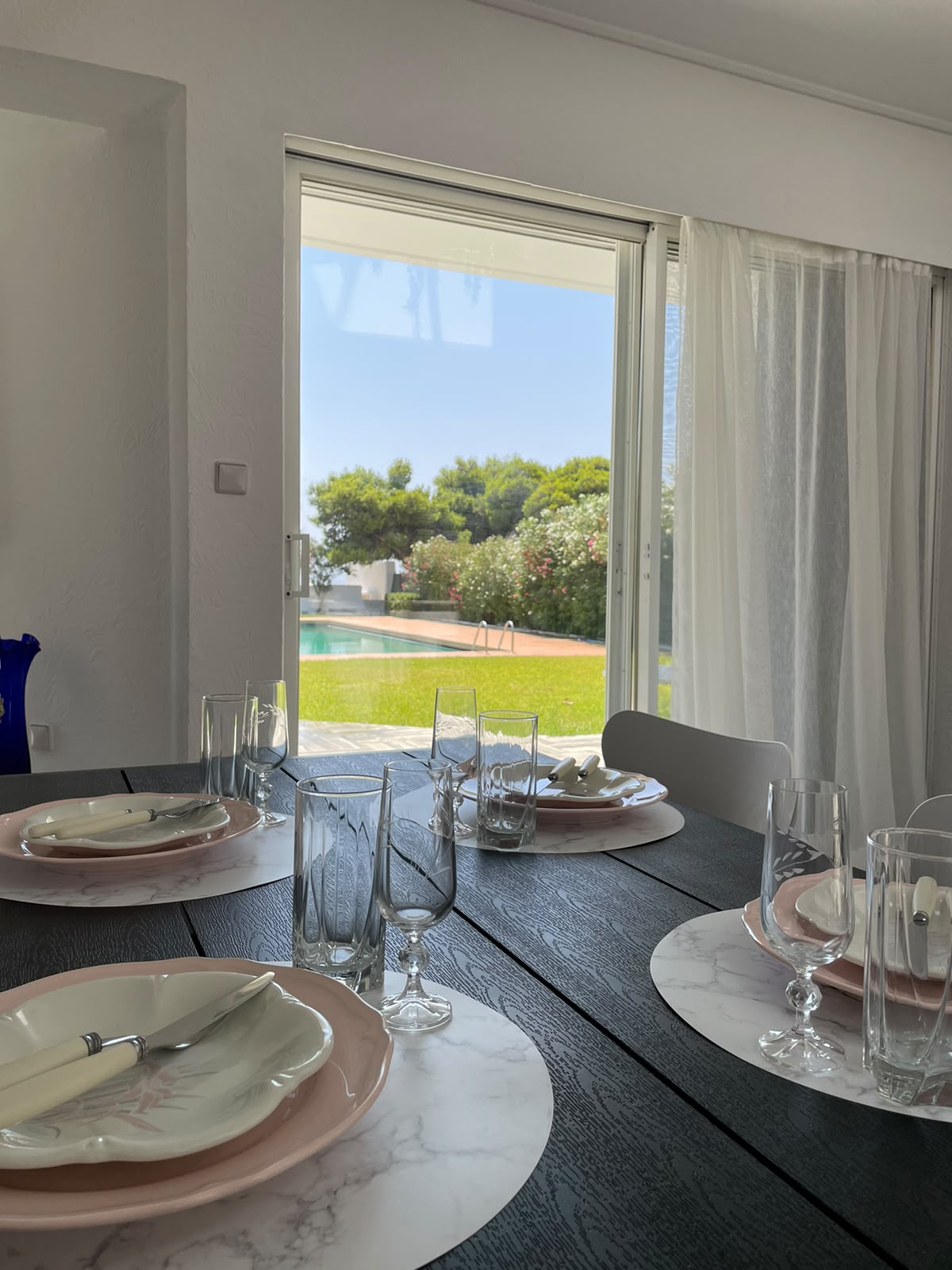 Dining table set for a meal with garden view