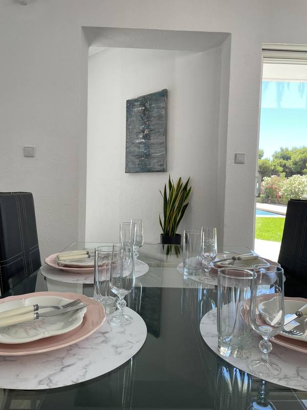 Dining table set for a meal with garden view