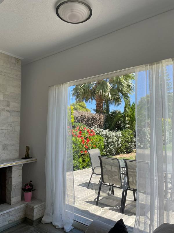 Living room with sliding doors open to the garden terrace